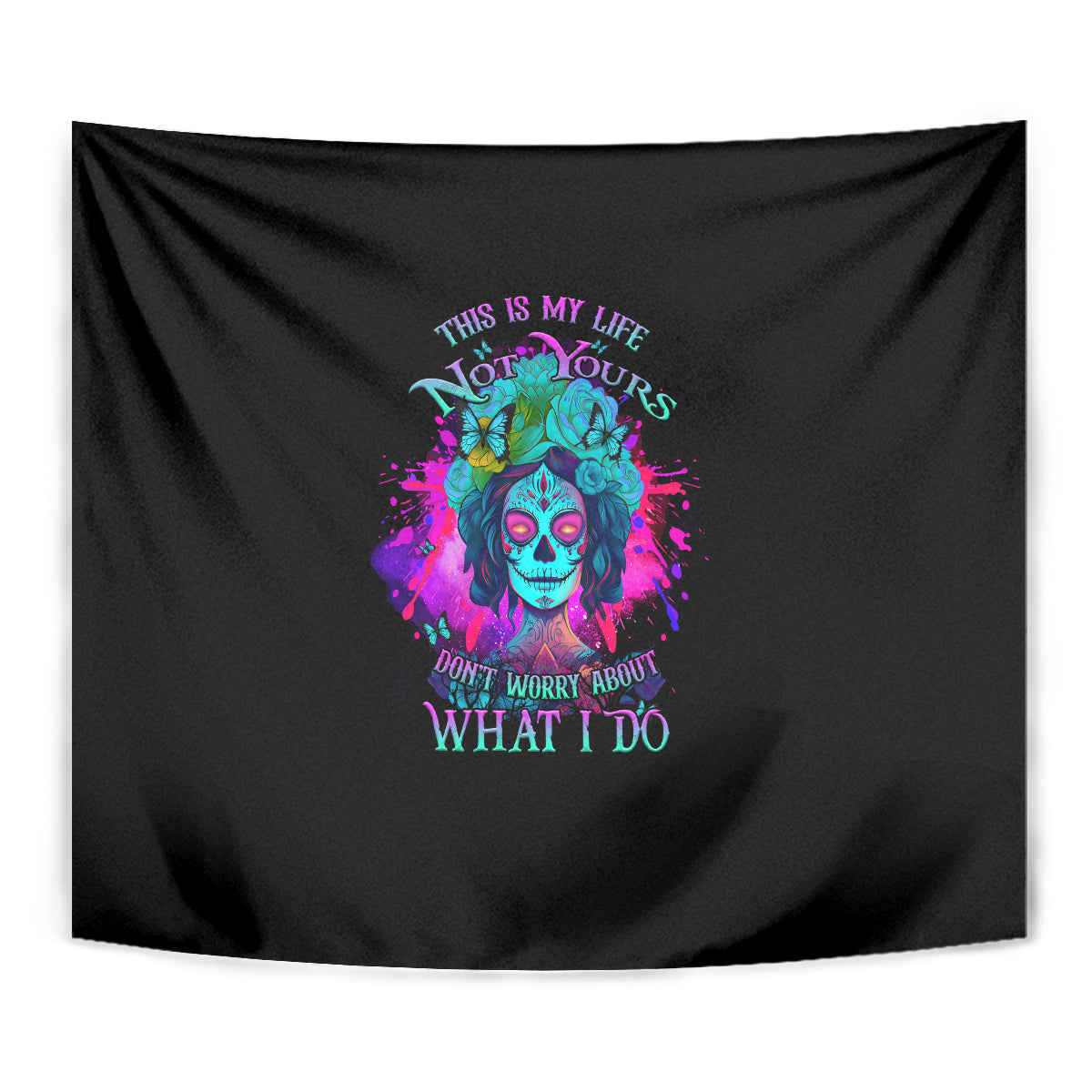 Black wall tapestry close view of colorful skull portrait and multicolor "what I do" text