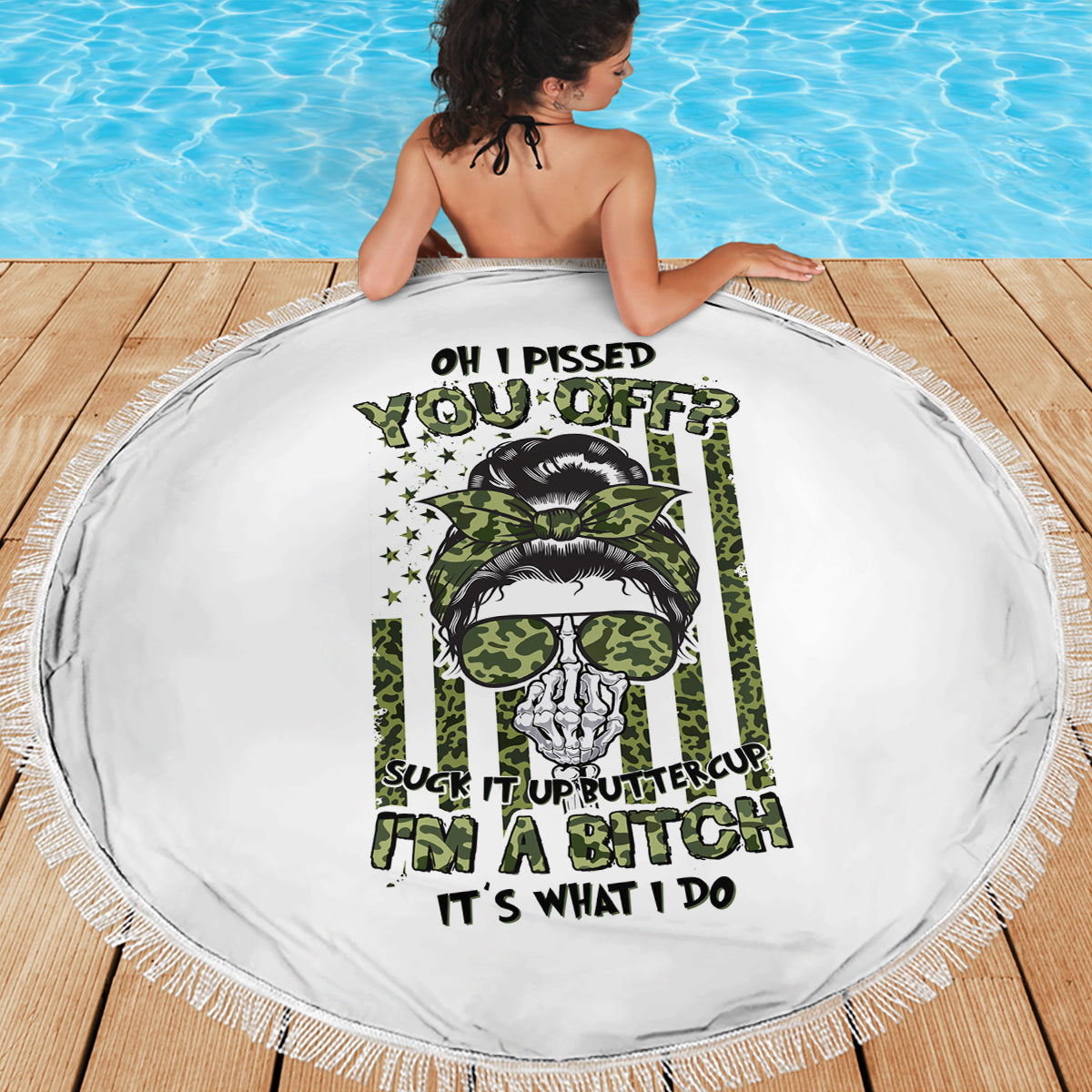 Round white beach blanket with fringed edge, green skull with sunglasses center graphic
