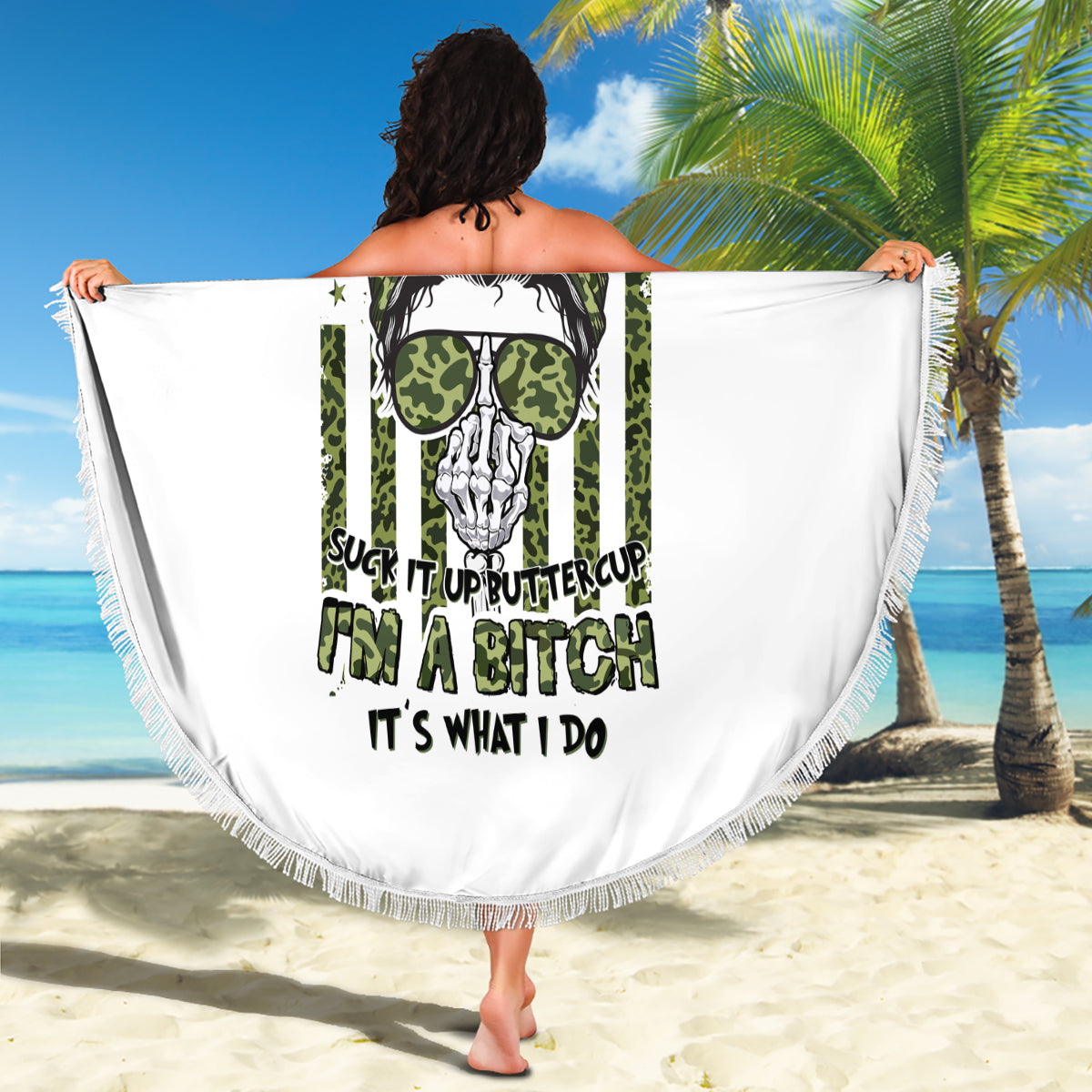 Round white beach blanket with fringed edge, green skull and sunglasses graphic held open