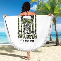 Round white beach blanket with fringed edge, green skull and sunglasses graphic held open