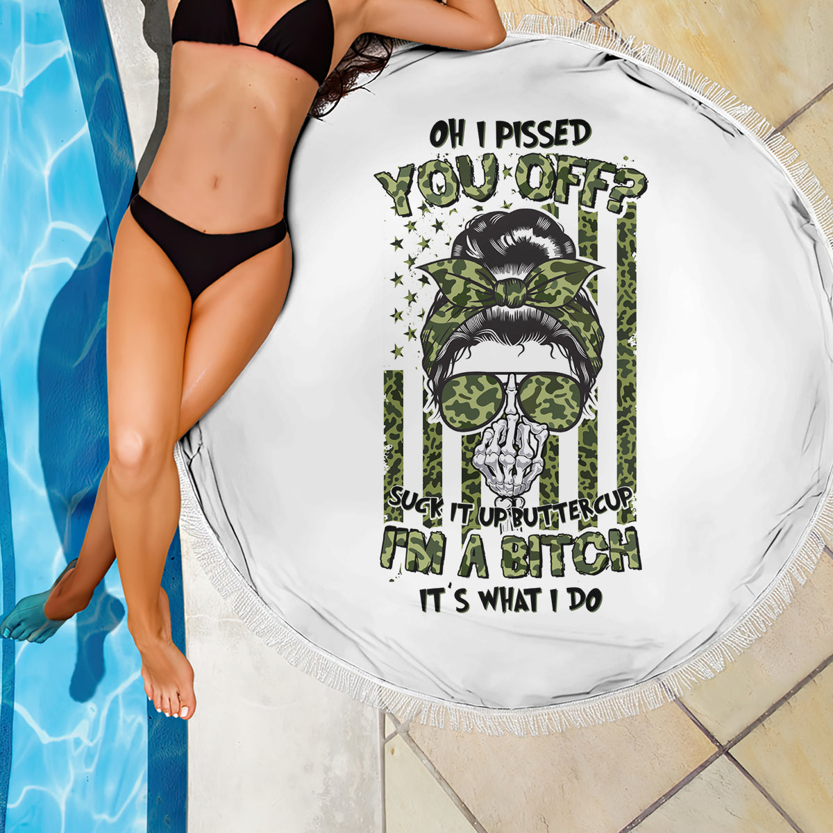 Round white beach blanket with fringed edge and green skull with sunglasses graphic close-up