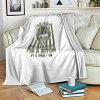 White fleece blanket with centered gray-and-green dripped graphic design
