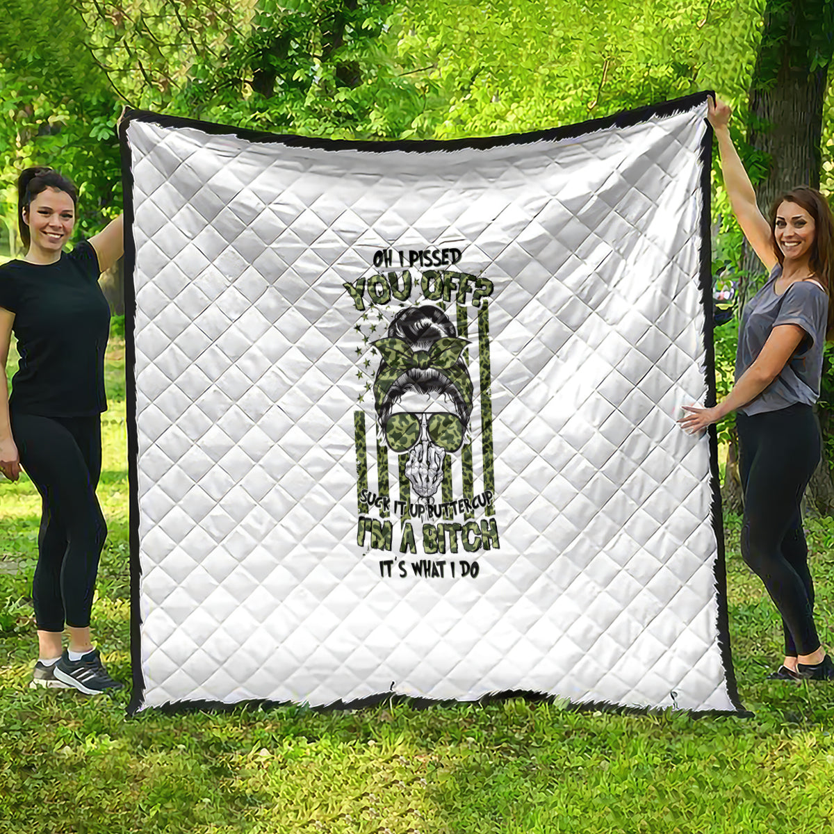 White quilt with diamond stitching and green/black character graphic, large square throw