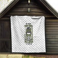 White quilted throw blanket with diamond quilting and green/black character graphic