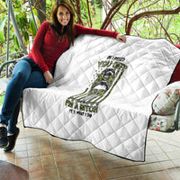 White diamond-stitched quilt spread over sofa seat with green/black character print