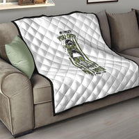 White quilted throw blanket with diamond stitching and centered green/black character art