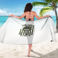White beach sarong with green and black graphic print, draped around waist