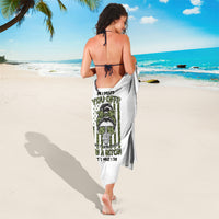 White sarong cover-up with green and black graphic print, tied at neck