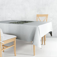 Light gray rectangular tablecloth, plain solid fabric with draped table edges.