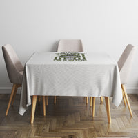 Light gray tablecloth on a dining table with a centered green graphic panel.