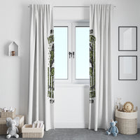 White window curtain set with green and black graphic print, hanging on top grommets