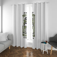 White window curtain panels with green and black graphic print, framed by a window