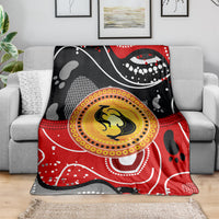 Abstract dot art kangaroo blanket in red and black with yellow center circle on sofa