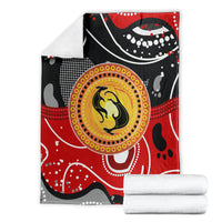 Folded red and black abstract dot art kangaroo blanket with yellow circular center motif