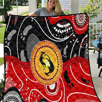 Multicolor quilt with black base, red accents, and central kangaroo dot-art medallion