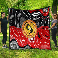 Multicolor abstract quilt with black, red, and gray sections plus a kangaroo dot-art circle