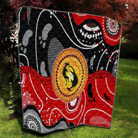 Multicolor black and red quilt featuring a central round kangaroo dot-art symbol