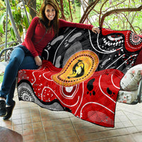 Multicolor quilt spread open with black, red, and gray abstract dot art and kangaroo medallion