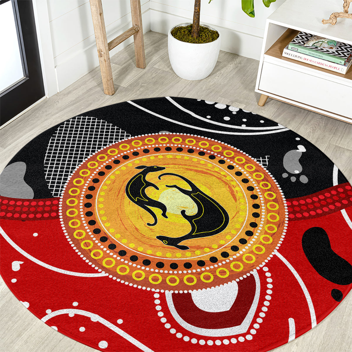 Round kangaroo dot art rug with red, yellow, black circular center and white accents