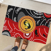 Red and black abstract kangaroo dot-art rubber doormat on patio floor, full view