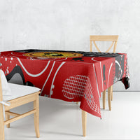 Red, black, and white abstract tablecloth with oval dot-art center on a dining table