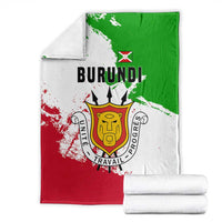 Burundi flag blanket folded with national emblem, shown beside white rolled towels