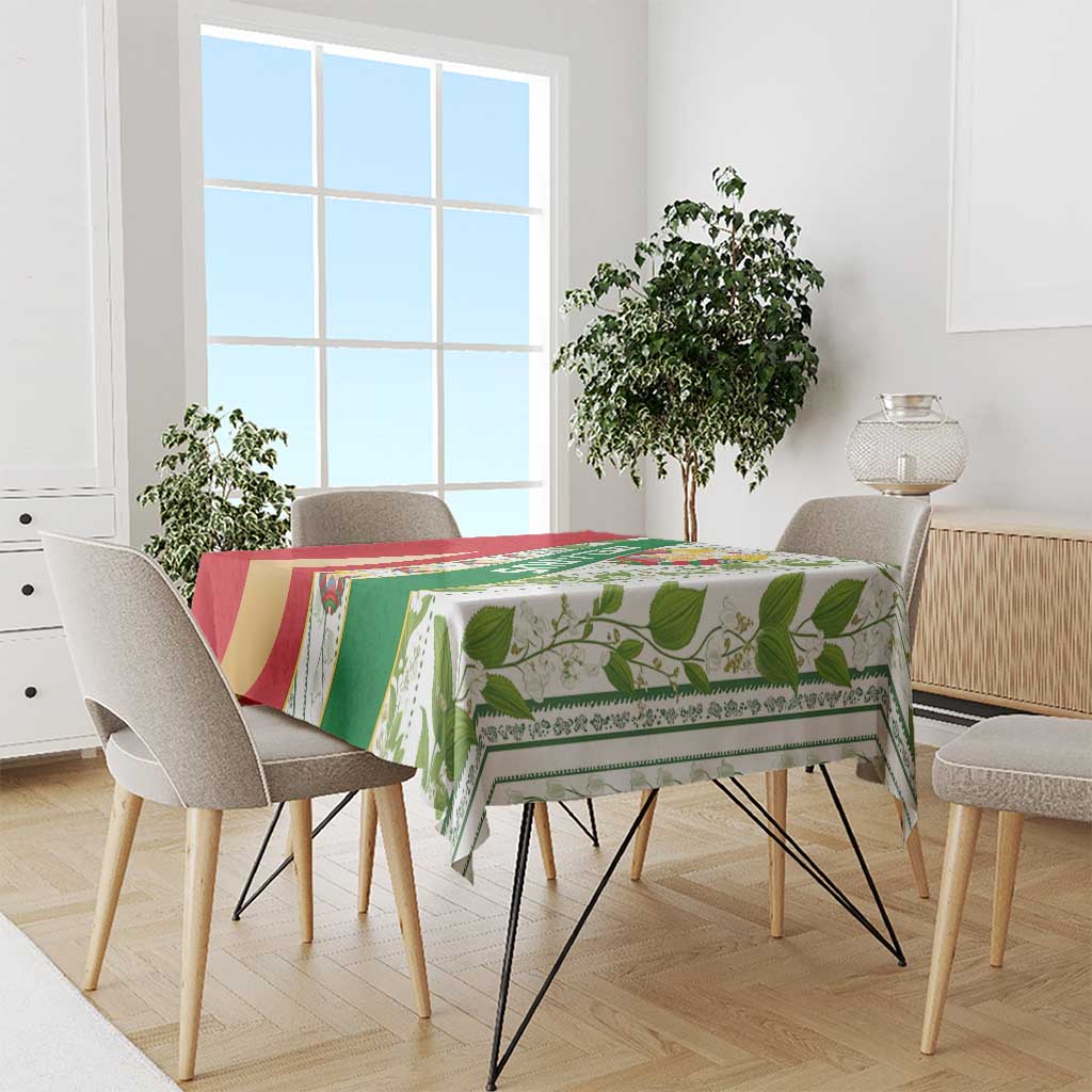 Multicolor Belarus folk tablecloth on dining table with green leaf motifs and emblem panel
