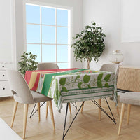 Multicolor Belarus folk tablecloth on dining table with green leaf motifs and emblem panel
