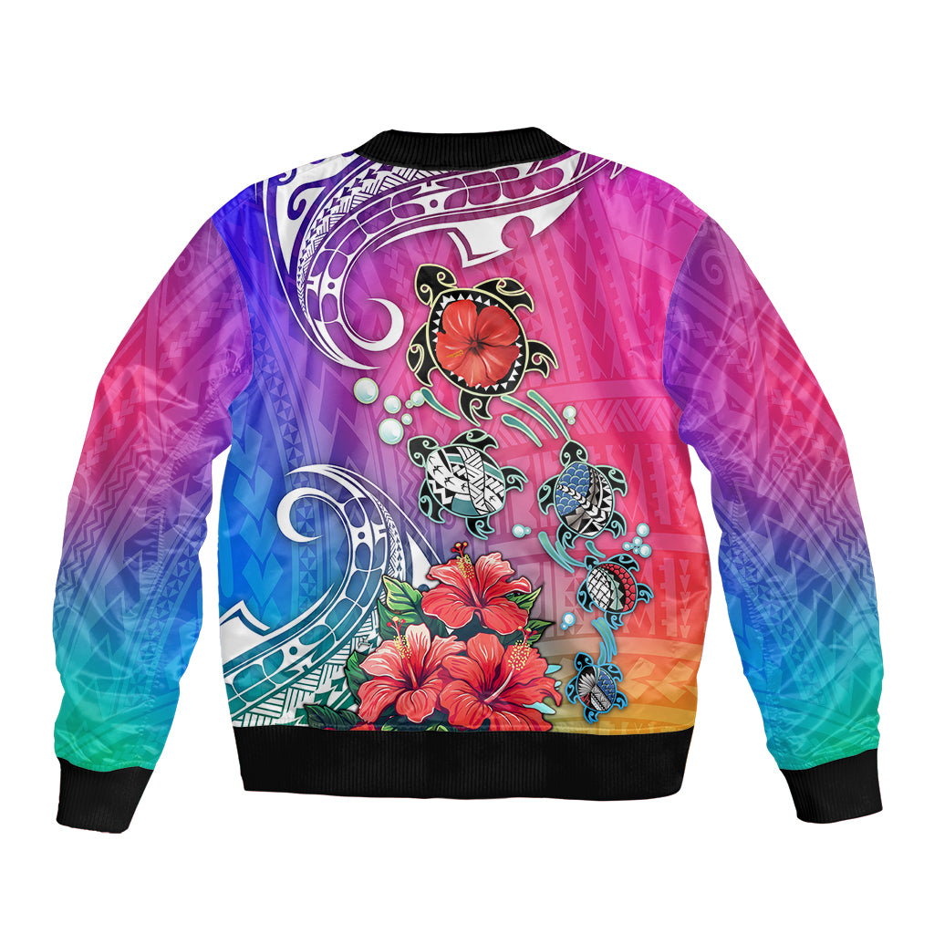 Unisex bomber jacket, back print with turtles and hibiscus on pink-blue gradient; ribbed hem.