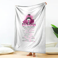 White throw blanket hung indoors, featuring a pink head graphic and slogan text