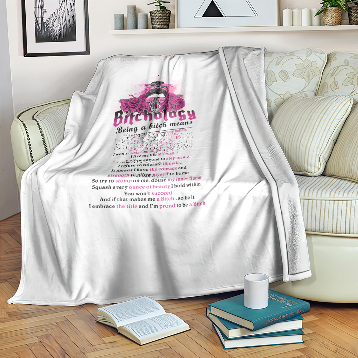 White throw blanket draped on sofa, with pink graphic logo and slogan text