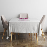 Light gray tablecloth with small multicolor print centered on top, corner drape