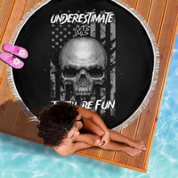 Round black beach blanket with skull graphic, 'Underestimate Me' text, and fringe edge