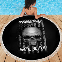 Round black beach blanket with skull design and 'Underestimate Me' wording, fringed edge