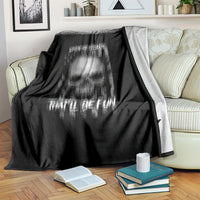 Black throw blanket with washed skull graphic, draped over a striped couch