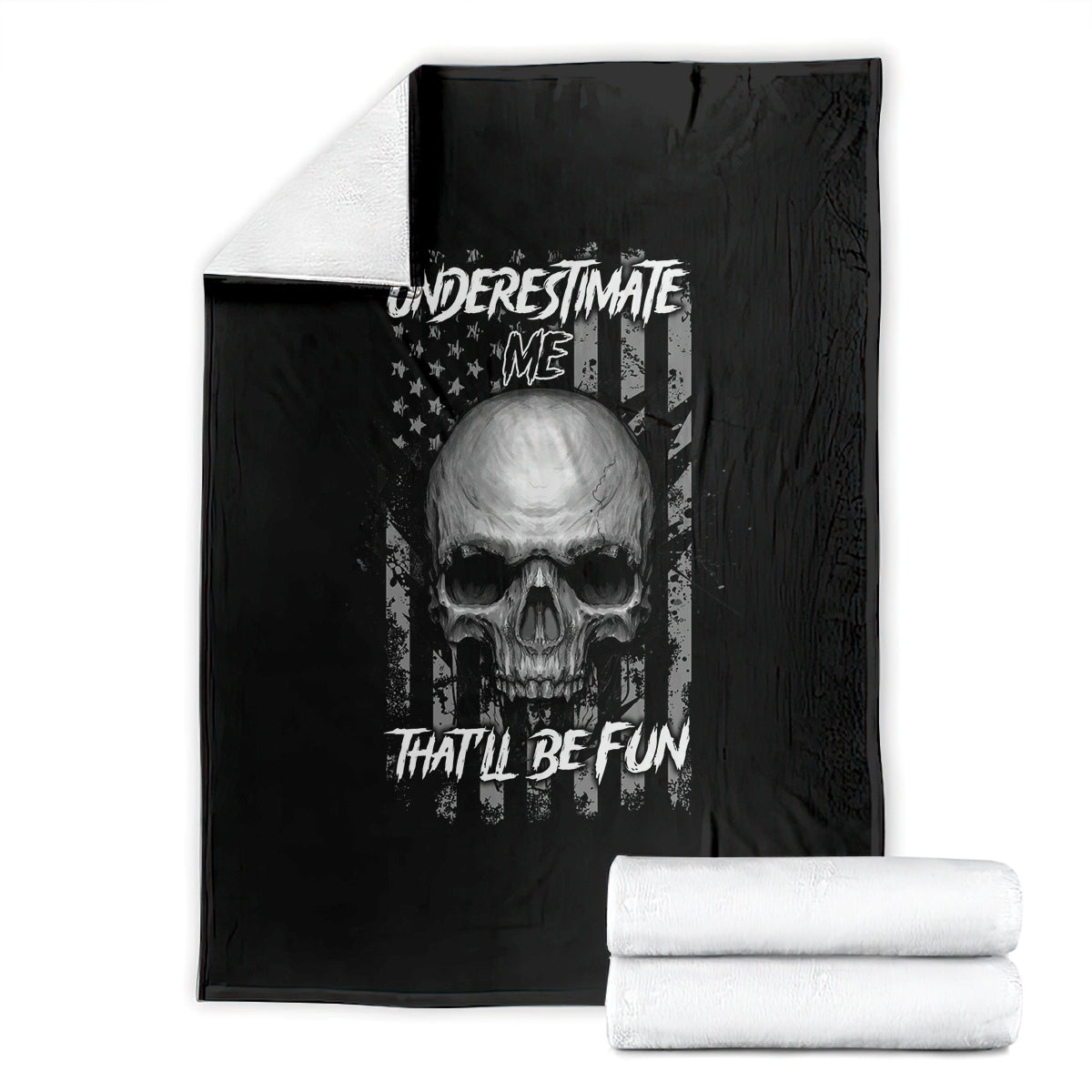 Black blanket with centered skull graphic, folded, with stacked white towels