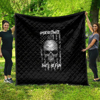 Black quilt with quilted diamond pattern and skull graphic with text, hanging outdoors