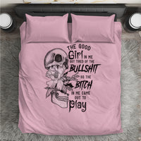 Pink duvet cover and pillowcases featuring a skull, flowers, and black typography design