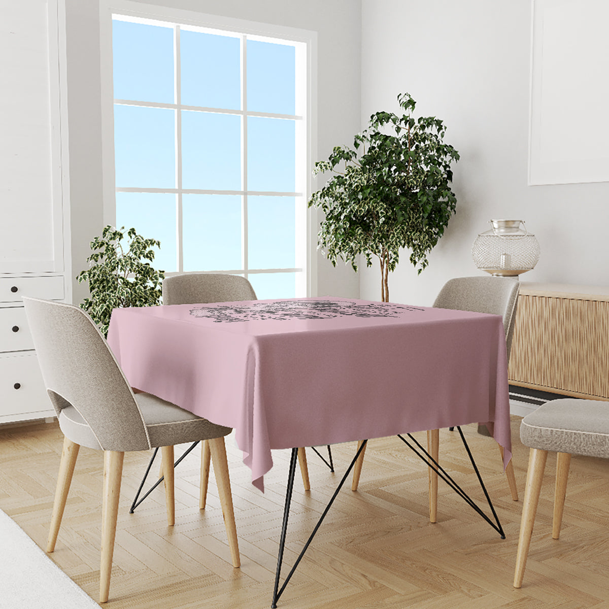 Mauve tablecloth with skull-themed print on dining table, hanging edges