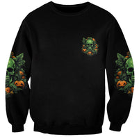 Black Halloween sweatshirt with small green skull and pumpkin graphic on chest.