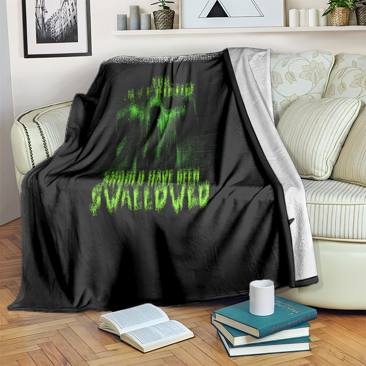 Black Halloween blanket draped on sofa with green skull graphic and lettering