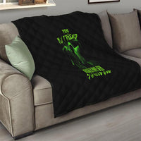 Black quilt on living room sofa with neon green monster artwork and text