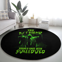 Black round Halloween rug with green alien skull graphic and 'Swallowed' lettering