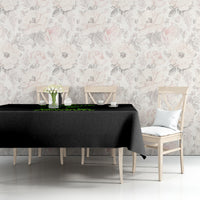 Black Halloween tablecloth with green neon text, draped over table with chairs