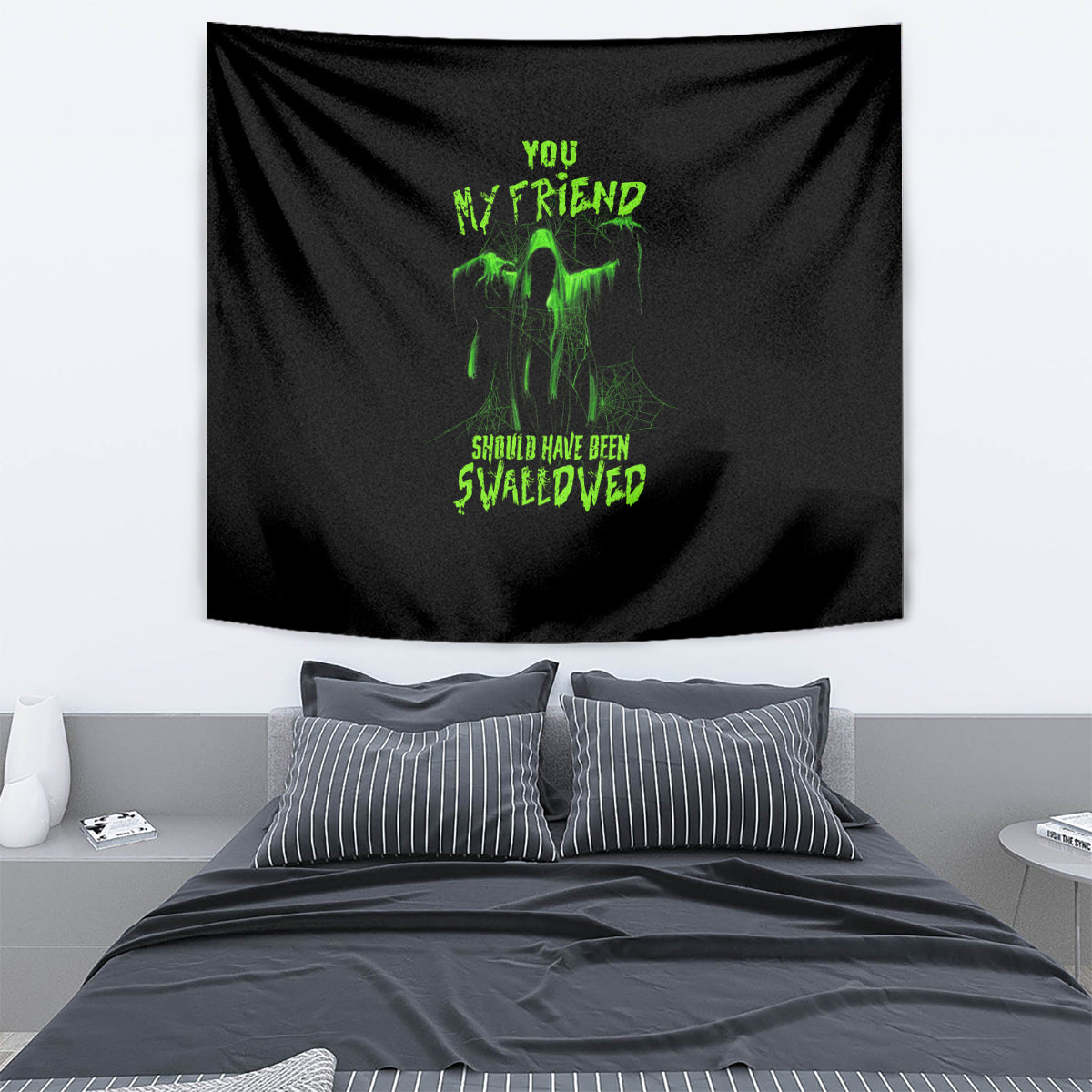 Halloween tapestry with black fabric and neon green graphic text, draped on wall