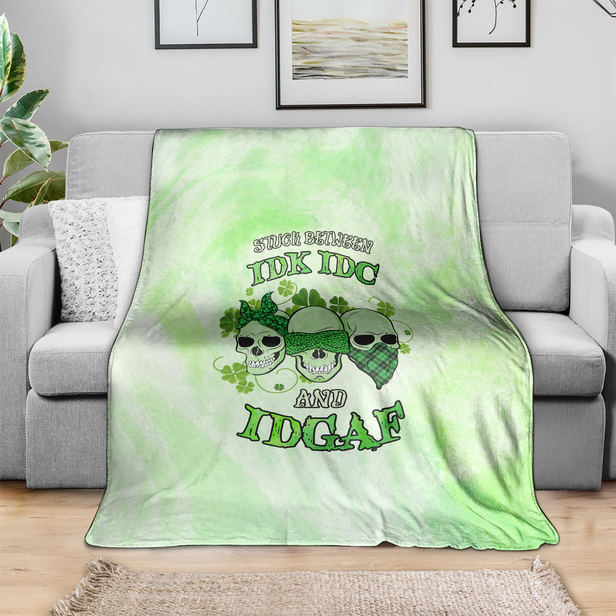 St. Patrick's Day green blanket with skull faces and bold text graphic, draped on sofa