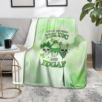 St. Patrick's Day green blanket with skull faces and stylized text graphic, on seat