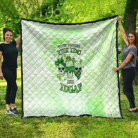 Green and white quilt with quilted diamond pattern and multicolor skull graphic, scalloped edges