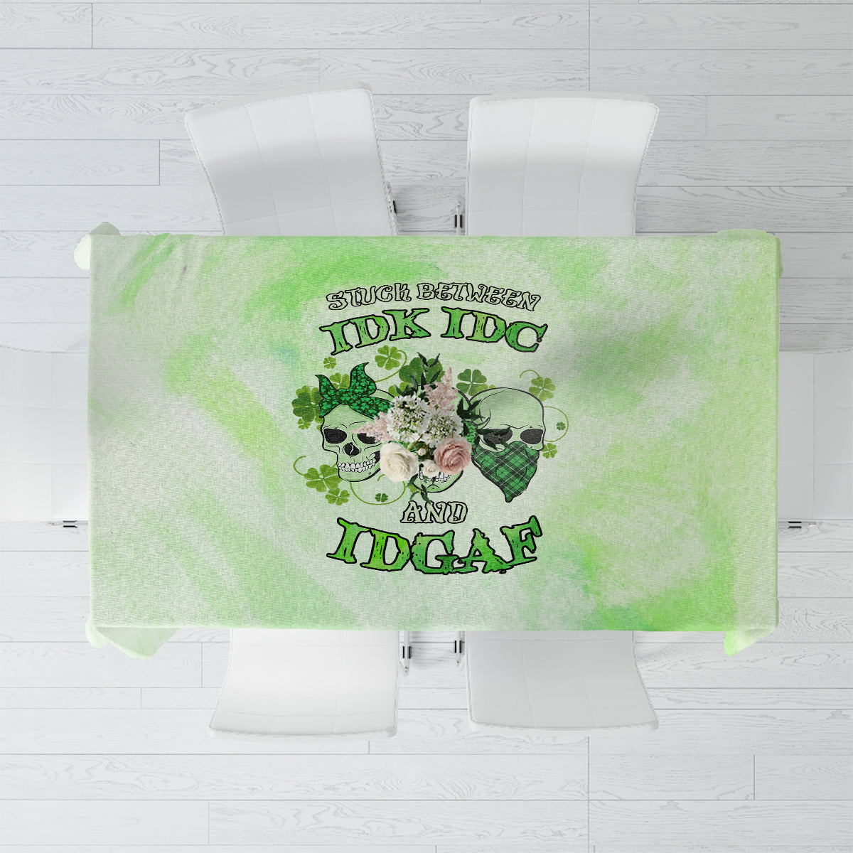 Green tablecloth, top view, skull and rose-themed text graphic centered on the fabric.