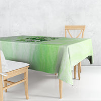 Green tablecloth with a skull-and-rose graphic in the center, draped over table corners.